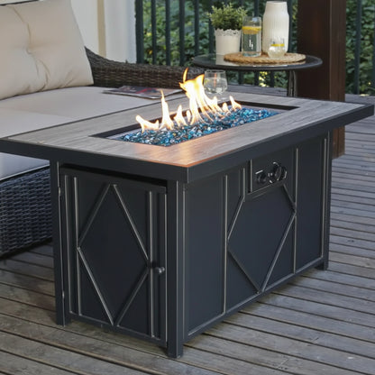 Outdoor fire pit table with flames on a wooden deck, surrounded by patio furniture.