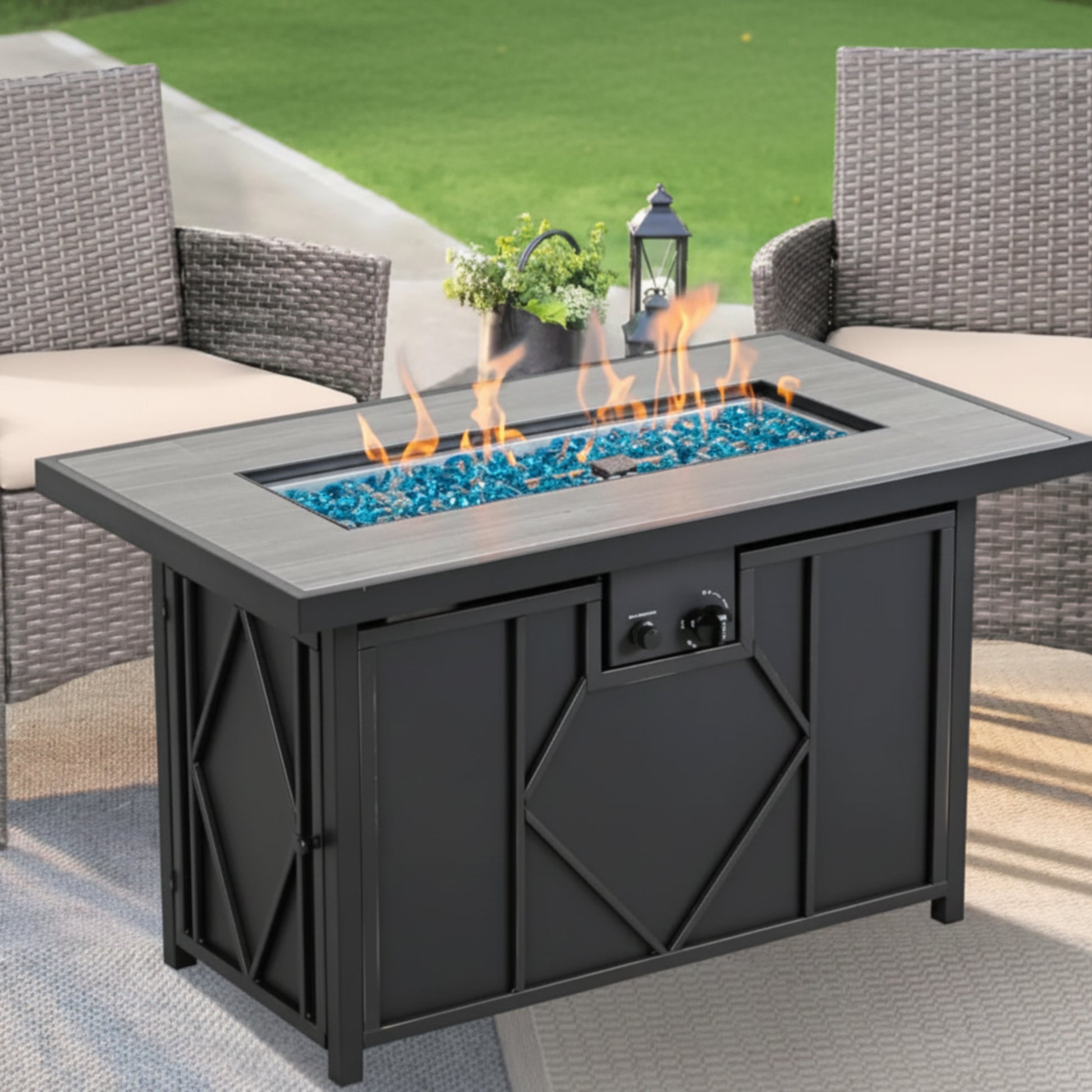 Outdoor fire pit table with flames and decorative stones in a patio setting.